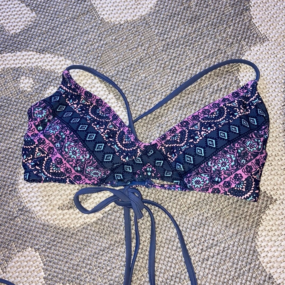 Purple, pink, and blue women’s bathing suit top.
